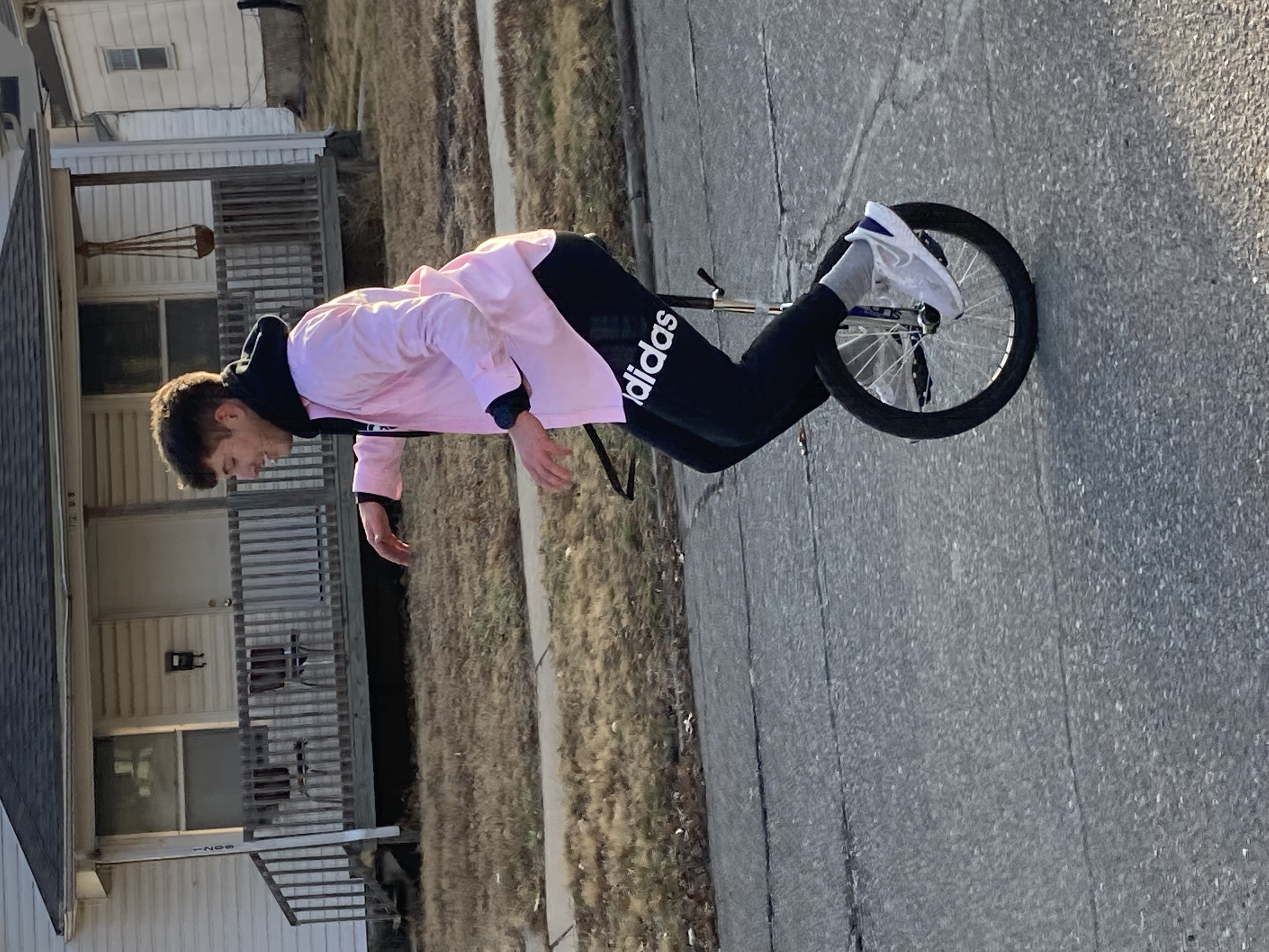 Ryan riding a unicycle in the middle of the street